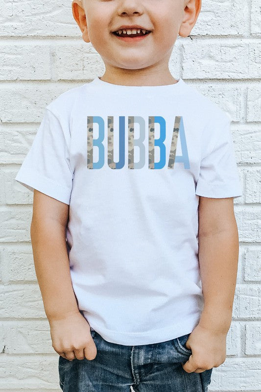 A child wearing a white short-sleeved t-shirt with the text 'BUBBA' printed in blue camo colorblock style on the front.