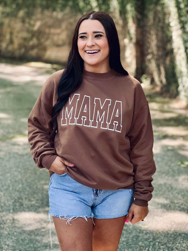 A person wearing an embroidered sweatshirt with the word 'mama' on the front, paired with denim shorts.