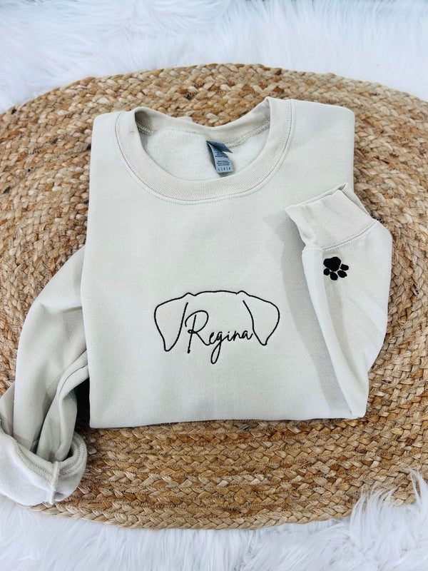 Beige sweatshirt with Dog Ears 'Regina' design on a woven mat